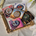Decorative bottle cap pins with various designs on a decorative tray